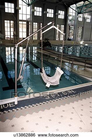 Image of a swim chair lift used to assist a person with a mobility impairment as they transfer from wheel chair to pool via this chair, which also provides a lift from the water to their wheelchair. View Large Photo Image Stock Photograph - Image of a swim chair lift used to assist a person with a mobility impairment as they transfer from wheel chair to pool via this chair, which also provides a lift from the water to their wheelchair.. Fotosearch