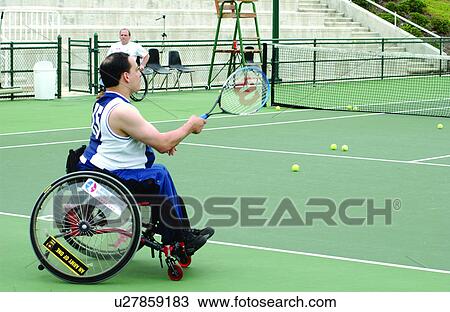 Man with a disability, utilizing a wheelchair for mobility, playing tennis with a friend at a local recreation center. View Large Photo Image Stock Image - Man with a disability, utilizing a wheelchair for mobility, playing tennis with a friend at a local recreation center.. Fotosearch