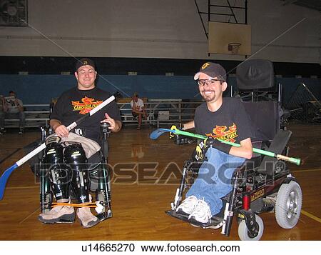 Men, in wheelchairs, playing hockey in gym. View Large Photo Image Stock Image - Men, in wheelchairs, playing hockey in gym.. Fotosearch