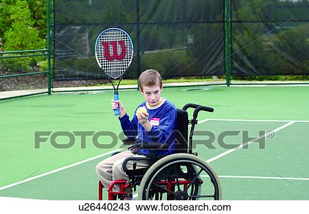 Young man with disabilities, utilizing a wheelchair for mobility, learning to play tennis from his instructor at their local recreation center. View Large Photo Image Stock Image - Young man with disabilities, utilizing a wheelchair for mobility, learning to play tennis from his instructor at their local recreation center.. Fotosearch