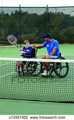 Young man with disabilities, with an instructor, both who utilize wheelchairs for mobility, learning to play tennis from his instructor at their local recreation center. View Large Photo Image Stock Image - Young man with disabilities, with an instructor, both who utilize wheelchairs for mobility, learning to play tennis from his instructor at their local recreation center.. Fotosearch