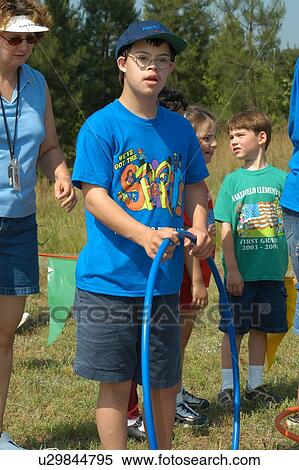 Stock Photography - Young man with Down’s Syndrome having a great time on the playground.. Fotosearch