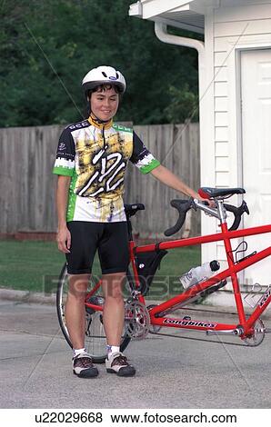 Stock Photo - Young woman with a disability preparing to embark on a bicycle ride.. Fotosearch