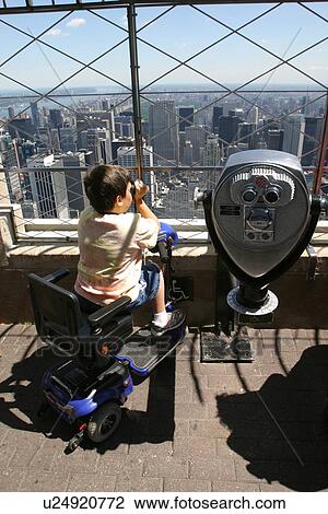 Boy with Muscular Dystrophy utilizing a scooter/cart using a viewer to see the sights. View Large Photo Image Stock Image - Boy with Muscular Dystrophy utilizing a scooter/cart using a viewer to see the sights.. Fotosearch
