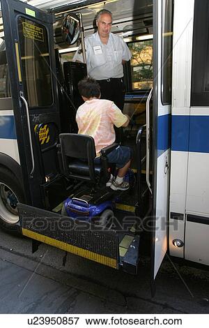 Boy with Muscular Dystrophy, utilizing a scooter/cart for mobility, getting on a city bus via a chair lift. View Large Photo Image Stock Photo - Boy with Muscular Dystrophy, utilizing a scooter/cart for mobility, getting on a city bus via a chair lift.. Fotosearch