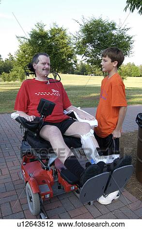 Man with significant disabilities, utilizing a powered wheelchair for mobility, spending time with his son in the park. View Large Photo Image Stock Image - Man with significant disabilities, utilizing a powered wheelchair for mobility, spending time with his son in the park.. Fotosearch