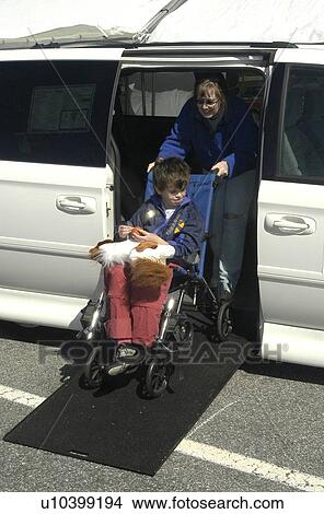 Mom and son (autistic) exit accessible van using ramp View Large Photo Image Picture - Mom and son (autistic) exit accessible van using ramp. Fotosearch