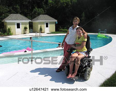 Mother and daughter (electric wheelchair user) relax by the accessible entrance to their pool. View Large Photo Image Stock Image - Mother and daughter (electric wheelchair user) relax by the accessible entrance to their pool.. Fotosearch