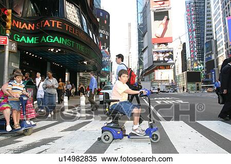 Mother and sons crossing a street in New York City, using scooters/carts, while vacationing there. View Large Photo Image Stock Photography - Mother and sons crossing a street in New York City, using scooters/carts, while vacationing there.. Fotosearch