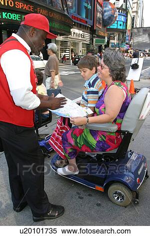 Stock Photography - Mother and sons getting directions from a guide in New York City.. Fotosearch