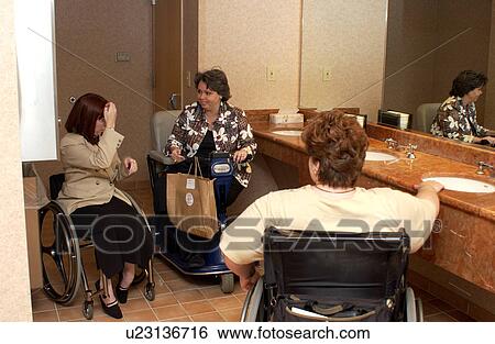 Three women chatting in the restroom. Each uses a wheelchair or scooter for mobility. View Large Photo Image Stock Photograph - Three women chatting in the restroom. Each uses a wheelchair or scooter for mobility.. Fotosearch