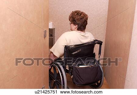 Woman with a disability, utilizing a wheelchair for mobility, rolling to a View Large Photo Image Stock Image - Woman with a disability, utilizing a wheelchair for mobility, rolling to a. Fotosearch