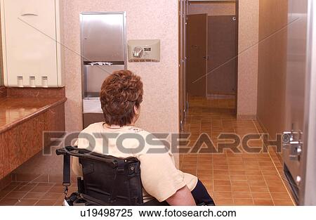 Woman with a disability, utilizing a wheelchair for mobility, rolling to a View Large Photo Image Stock Photography - Woman with a disability, utilizing a wheelchair for mobility, rolling to a. Fotosearch