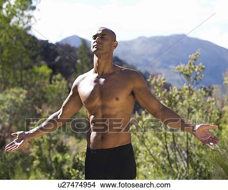 Bare chested young man meditating View Large Photo Image Picture - Bare chested young man meditating . Fotosearch
