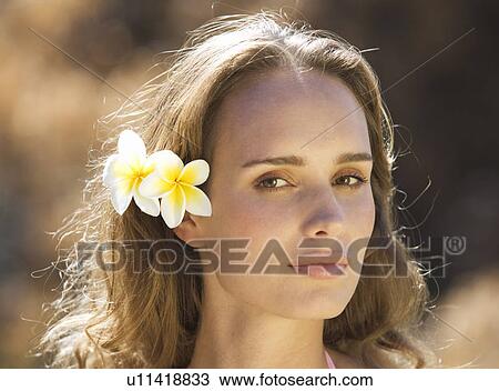Portrait of a young woman with flowers in her hair, close-up View Large Photo Image Stock Image - Portrait of a young woman with flowers in her hair, close-up. Fotosearch