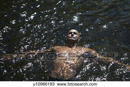 Young man swimming View Large Photo Image Stock Image - Young man swimming. Fotosearch