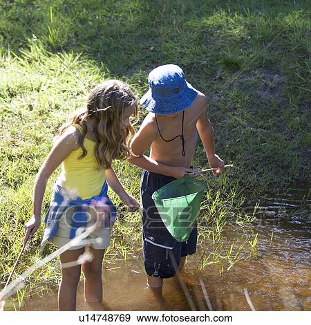 A young boy and girl with a fishing net View Large Photo Image Stock Photo - A young boy and girl with a fishing net. Fotosearch