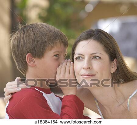 A young boy whispering to his mother View Large Photo Image Picture - A young boy whispering to his mother. Fotosearch