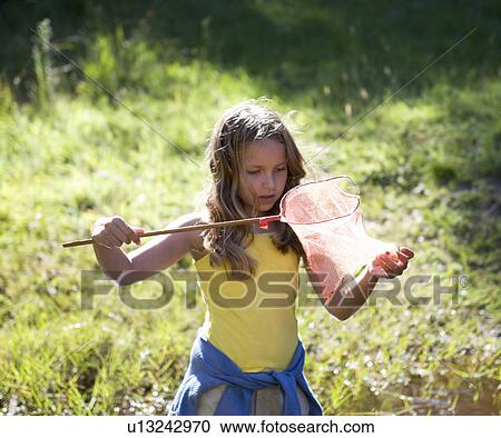 A young girl with a fishing net View Large Photo Image Stock Image - A young girl with a fishing net. Fotosearch