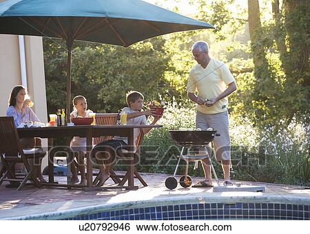 Stock Photograph - Family barbeque on the patio. Fotosearch