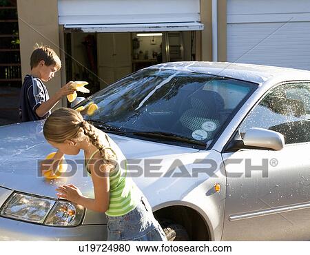 Young girl and boy washing a car View Large Photo Image Stock Image - Young girl and boy washing a car. Fotosearch