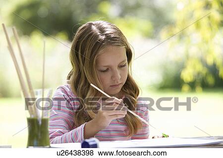 Young girl painting View Large Photo Image Stock Photo - Young girl painting. Fotosearch