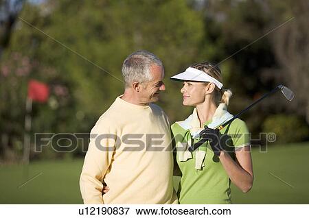 Stock Photo - Couple playing golf. Fotosearch