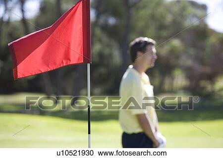 Flag on a golf course, close-up View Large Photo Image Stock Image - Flag on a golf course, close-up. Fotosearch