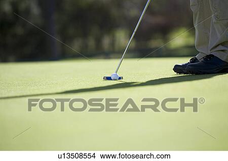 Man playing golf, close-up of feet and putter View Large Photo Image Picture - Man playing golf, close-up of feet and putter. Fotosearch
