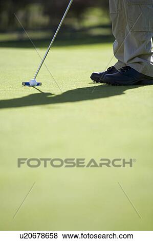Man playing golf, close-up of feet and putter View Large Photo Image Stock Photo - Man playing golf, close-up of feet and putter. Fotosearch