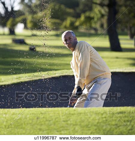 Stock Photo - Man playing golf. Fotosearch