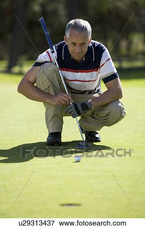Stock Photo - Man playing golf. Fotosearch