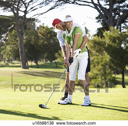 Man teaching a woman how to play golf View Large Photo Image Stock Photo - Man teaching a woman how to play golf. Fotosearch