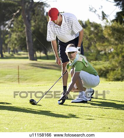 Man teaching a woman how to play golf View Large Photo Image Stock Photograph - Man teaching a woman how to play golf. Fotosearch