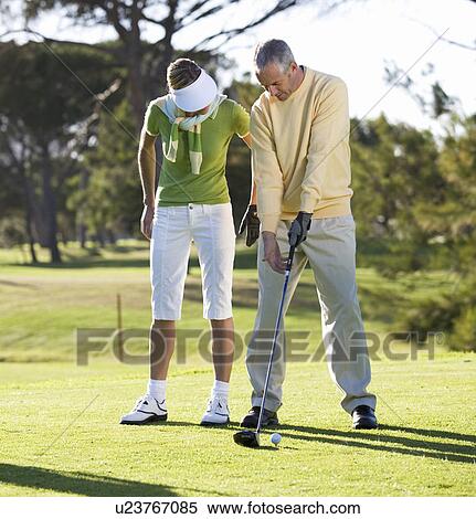 Man teaching a woman how to play golf View Large Photo Image Stock Photography - Man teaching a woman how to play golf. Fotosearch