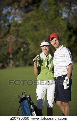 Stock Image - Two friends playing golf. Fotosearch