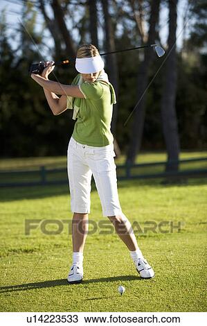 Woman playing golf View Large Photo Image Stock Image - Woman playing golf. Fotosearch