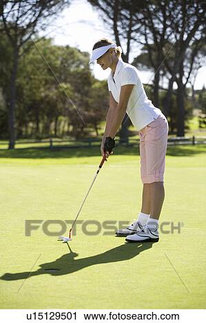 Woman putting on a green View Large Photo Image Stock Image - Woman putting on a green. Fotosearch