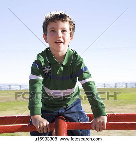 Stock Photo - A young boy on a playground. Fotosearch