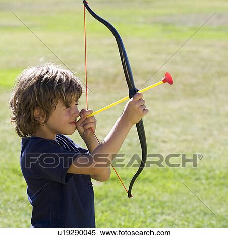 A young boy with a toy bow and arrow View Large Photo Image Stock Photography - A young boy with a toy bow and arrow. Fotosearch