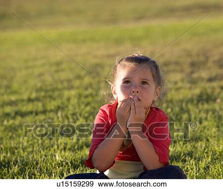 Stock Photo - A young girl looking skyward. Fotosearch