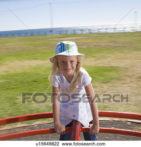 Stock Image - A young girl on a playground. Fotosearch