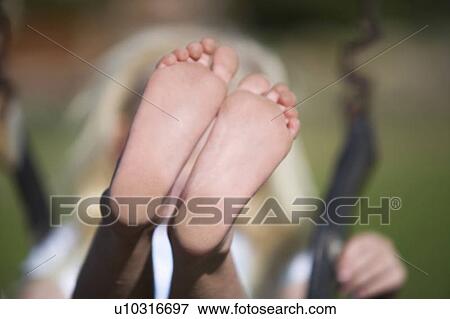 A young girl on a swing, close-up of feet View Large Photo Image Stock Photo - A young girl on a swing, close-up of feet. Fotosearch