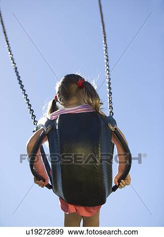 Stock Photo - A young girl on a swing. Fotosearch
