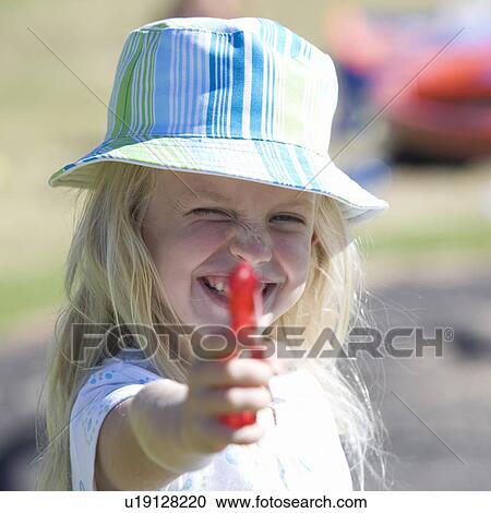 A young girl with a water pistol View Large Photo Image Stock Image - A young girl with a water pistol. Fotosearch