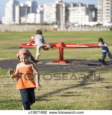 Three children on a playground View Large Photo Image Stock Image - Three children on a playground. Fotosearch