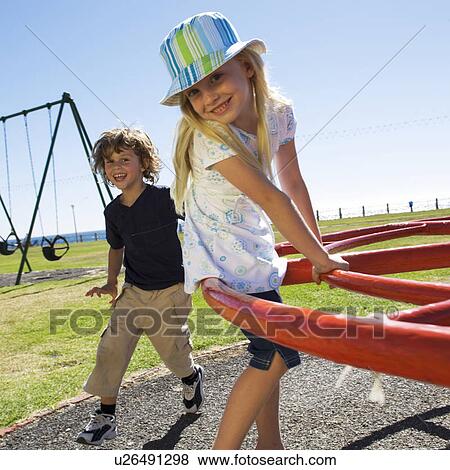 Two young children on a playground View Large Photo Image Stock Photo - Two young children on a playground. Fotosearch