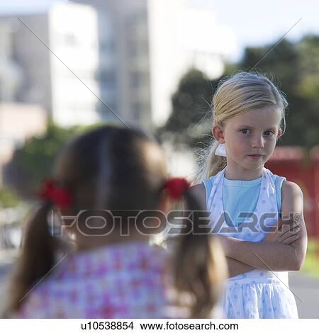 Picture - Two young girls at a school playground. Fotosearch