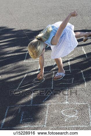 Young girl playing hopscotch View Large Photo Image Stock Photograph - Young girl playing hopscotch. Fotosearch
