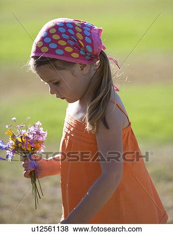 Young girl with a bunch of wildflowers View Large Photo Image Stock Photo - Young girl with a bunch of wildflowers. Fotosearch